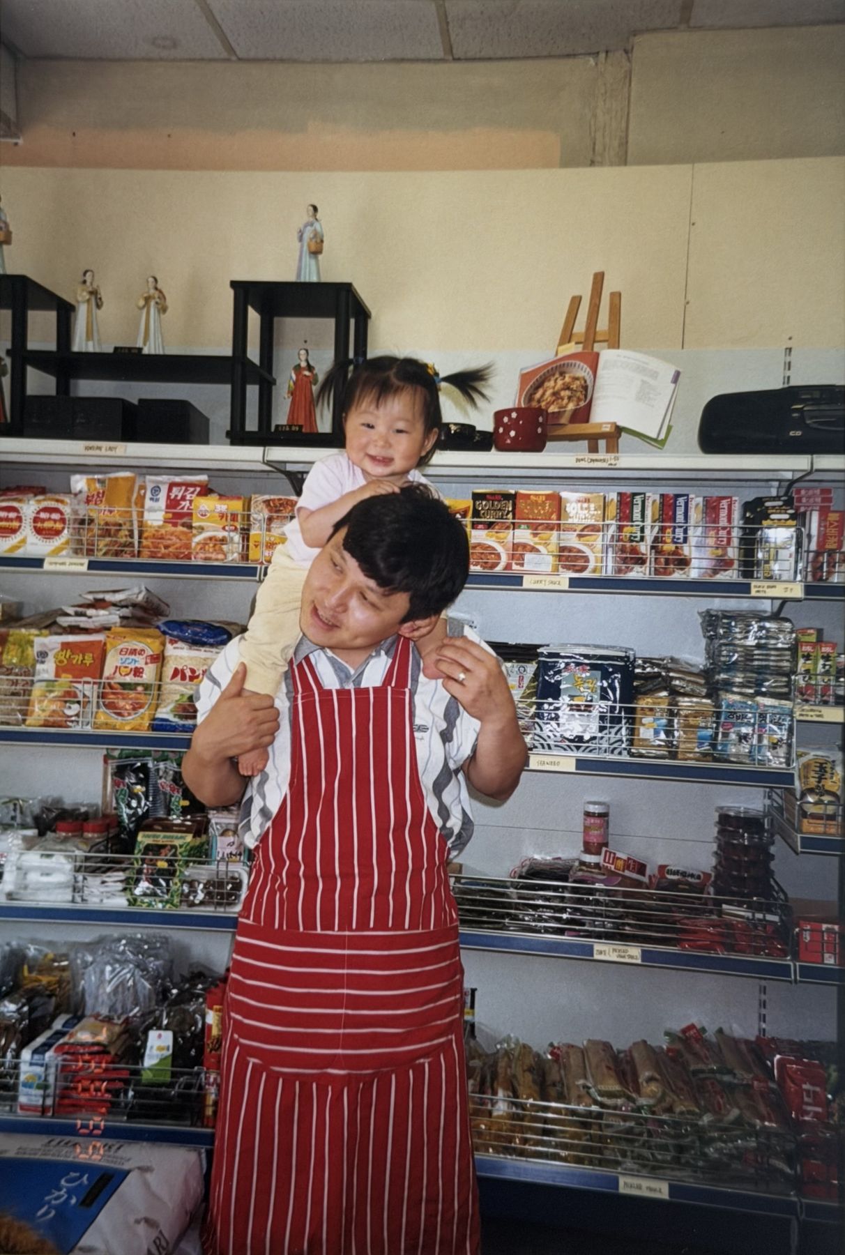 Jason Park with Cindy on his shoulders inside the shop, 1999