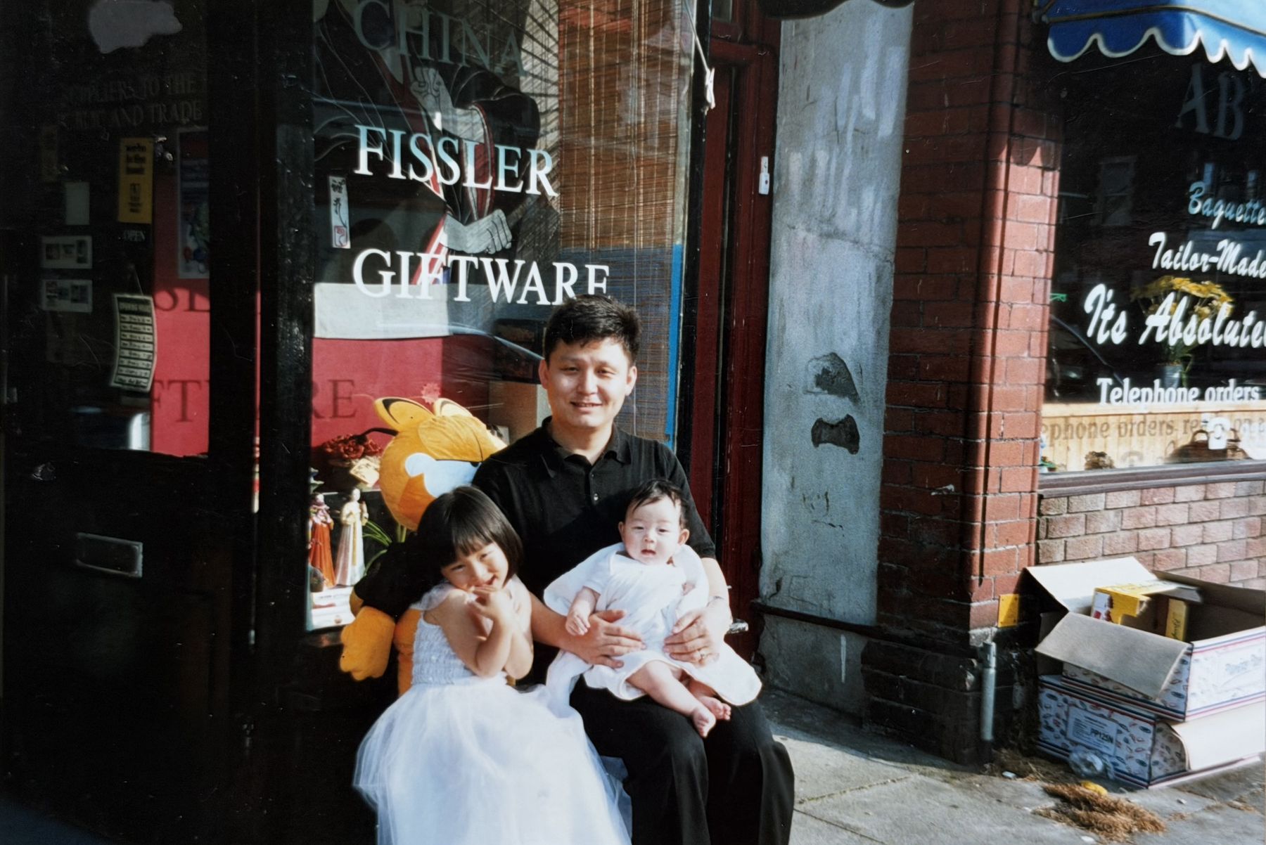 Jason, Cindy and Sean Park outside the shop, 2002