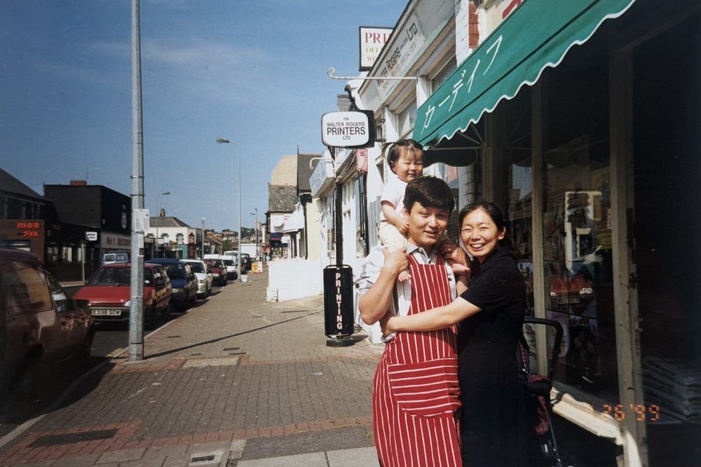 Jason and Cindy Park with their daughter outside the shop, 1999