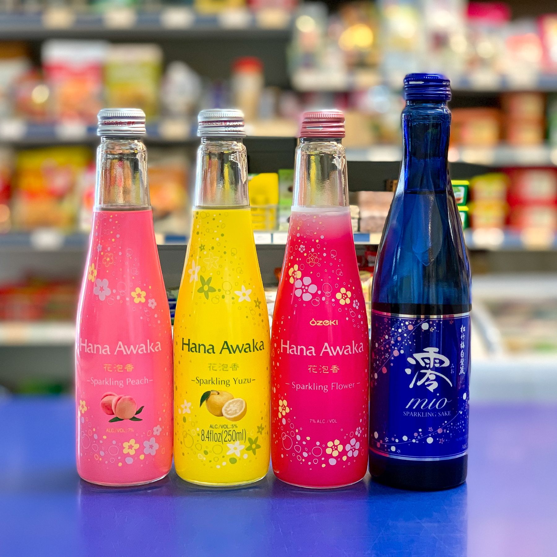 Bottles of Hana Awaka sparkling peach, yuzu and flower drinks with Mio sparkling sake