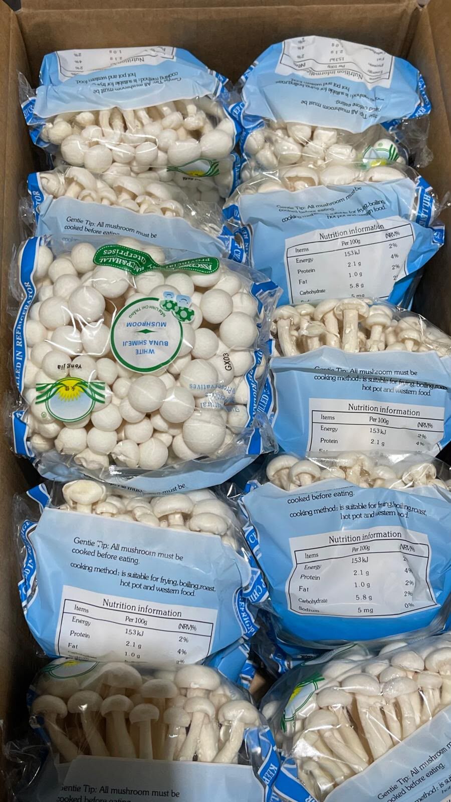 Packs of fresh white shimeji (buna-shimeji) mushrooms