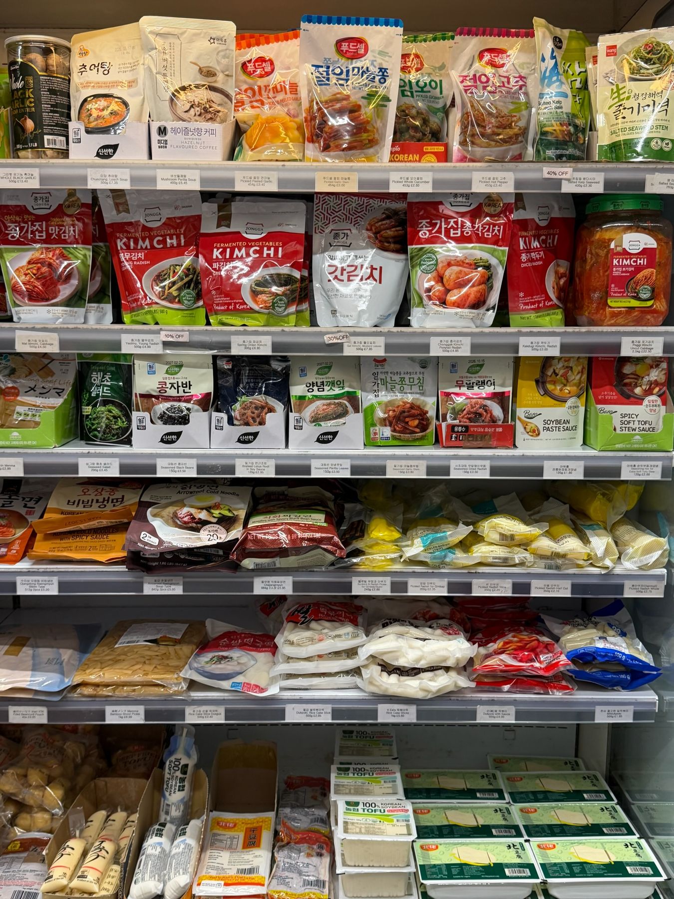 Chilled cabinet with kimchi, banchan side dishes, tofu and rice cakes