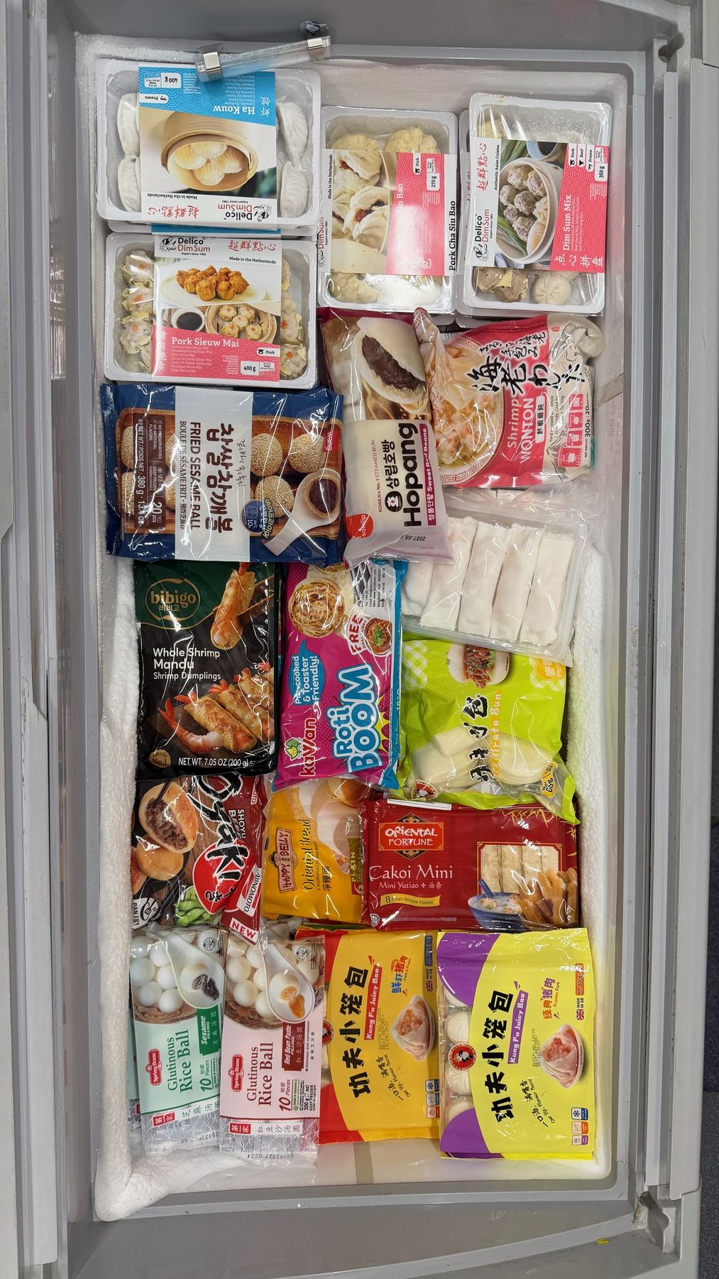 Freezer of dim sum including har gow, siu mai, char siu bao and shrimp wontons