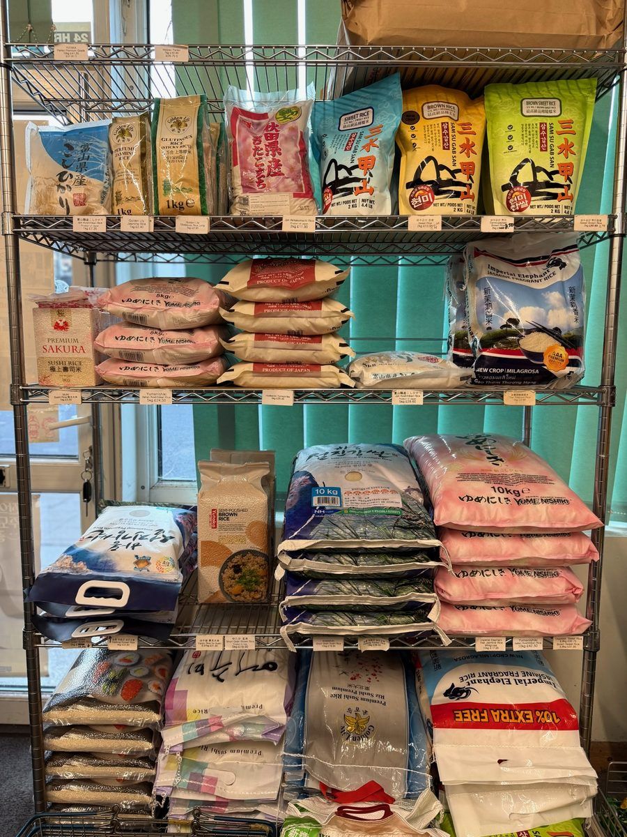 Bags of Japanese and Korean rice stacked on shelving